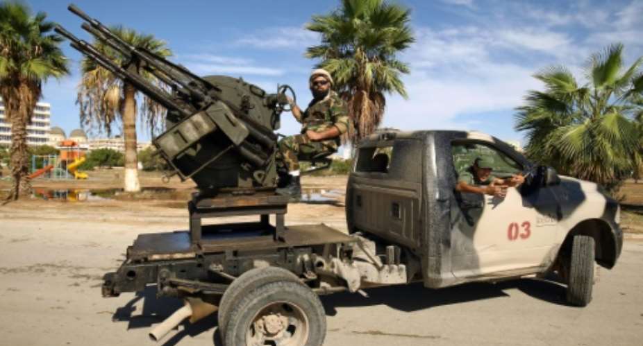 Forces loyal to Libyan strongman Khalifa Haftar man pickup trucks in Benghazi on October 24, 2018.  By Abdullah DOMA AFP