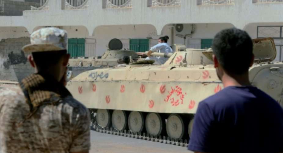 Forces loyal to Libya's UN-backed government gather next to tanks on August 27, 2016 in Sirte during a military operation to clear the Islamic State group from the city.  By Mahmud Turkia AFP