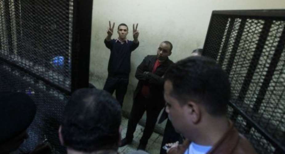 Some of the fourteen Egyptian activists are seen during their trial on February 26.  By Khaled Desouki AFPFile