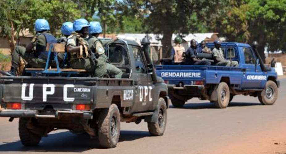 Police and gendarmes assisted by UN troops MINUSCApatrol in the capital Bangui on October 2, 2014.  By Pacome Pabandji AFPFile