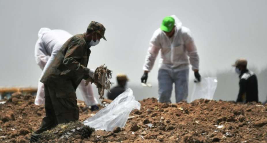 Forensics experts shown in March 2019 combing through the crash site of an Ethiopian Airlines operated Boeing 737 MAX aircraft.  By TONY KARUMBA AFPFile