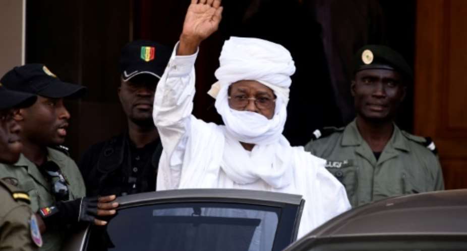 Former Chadian dictator Hissene Habre gestures as he leaves a Dakar courthouse after an identity hearing in June 2015.  By SEYLLOU AFPFile