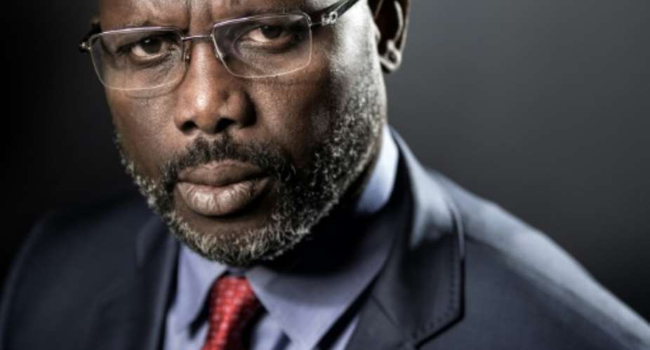 Former football player George Weah is leading the race for Liberia's presidency, with around one third of votes counted.  By JOEL SAGET AFP