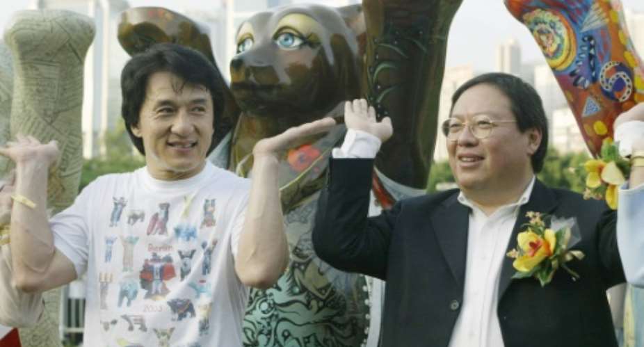 Former Hong Kong home affairs secretary Patrick Ho Chi Ping R, pictured in a 2003 photograph with movie star Jackie Chan, was sentenced to three years in prison over a bribery scheme.  By SAMANTHA SIN AFPFile
