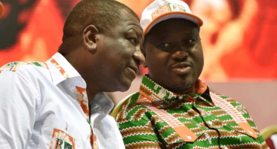 Former Ivorian rebel chief Guillaume Soro, seen here on the right, has said he is stepping down as parliamentary leader.  By SIA KAMBOU AFPFile
