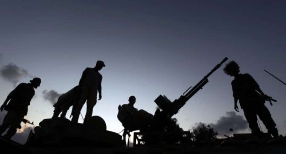 Libyan rebels guard an outpost on the outskirts of Sirte.  By Ahmad al-Rubaye (AFP/File)