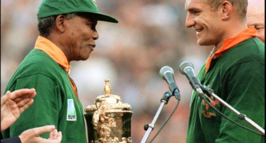 Nelson Mandela hands South Africa captain Franois Pienaar the Webb Ellis Cup at the end of the 1995 Rugby World Cup final between South Africa and New Zealand in Johannesburg on June 24, 1995.  By Jean-Pierre Muller AFPFile