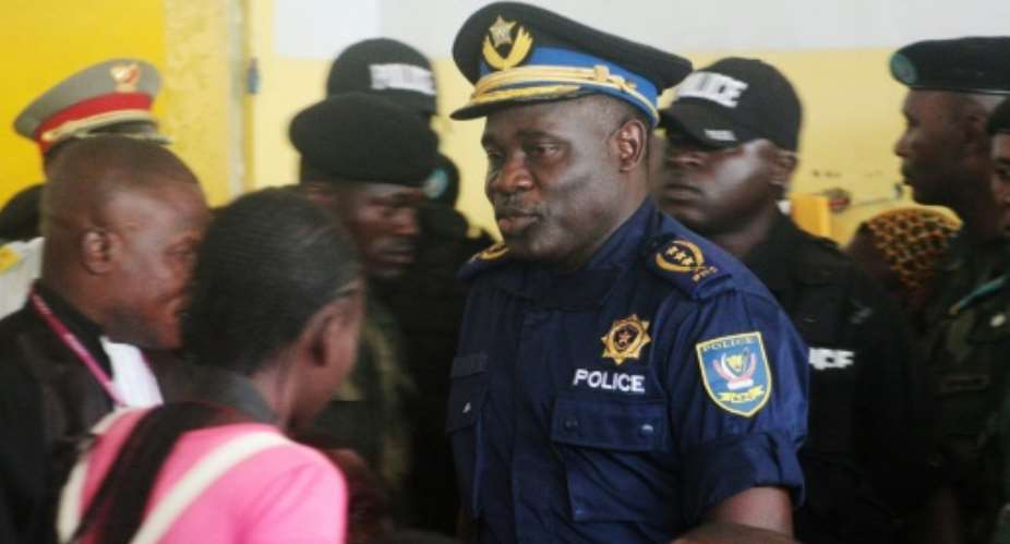 Former police chief John Numbi, centre, pictured in January 2011 at the trial of policemen accused of killing rights activist Floribert Chebeya.  By Junior KANNAH AFP