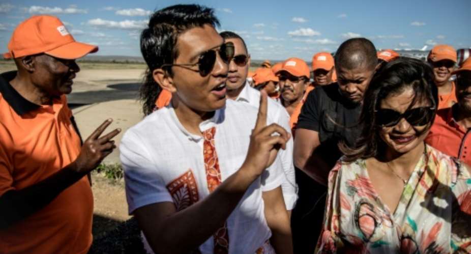 Former president and current candidate Andry Rajoelina, flanked by his wife Mialy Rajoelina, placed first but faces a second round vote in December.  By MARCO LONGARI (AFP)