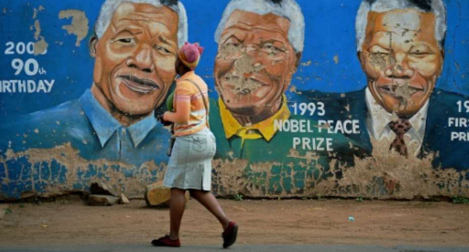 Former president Nelson Mandela attracts tourists to Soweto even though many question South Africa's democracy since his passing.  By Carl DE SOUZA AFPFile