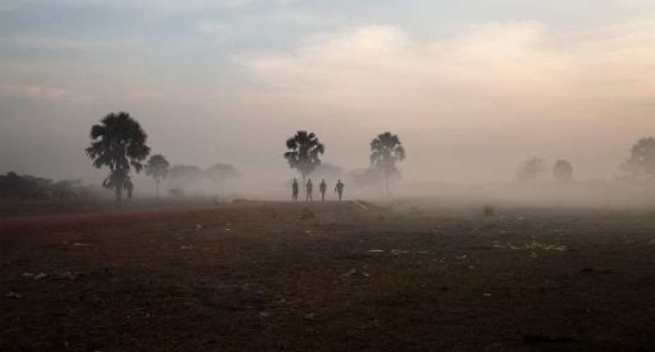 Government soldiers walk along the road that connects the central South Sudanese town of Yirol with the north of the country on February 12, 2014.  By Fabio Bucciarelli AFPFile