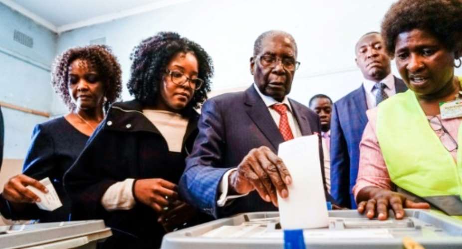 Former Zimbabwean president Robert Mugabe C, his daughter Bona C and wife Grace L cast their votes at a polling station in the Highfields district of Harare.  By Zinyange AUNTONY AFP