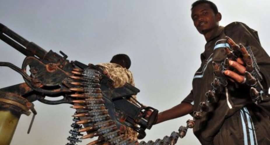 A Sudanese soldier poses with a machine gun in the oil town of Heglig.  By Ebrahim Hamid (AFP/File)