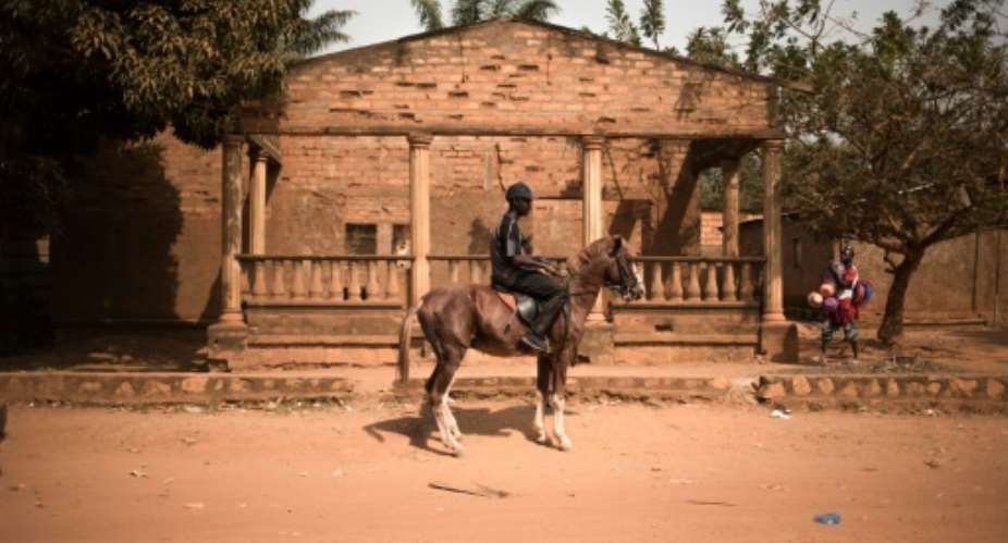 Four legs good: Soumaila Zacharia Maidjida, alias Dida, and one of his beloved horses.  By FLORENT VERGNES AFP