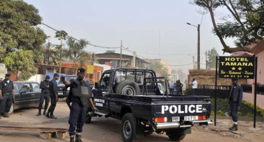 Policemen block the street near La Terrasse restaurant, in Bamako, Mali on March 7, 2015, after five people were shot dead.  By Habibou Kouyate AFPFile