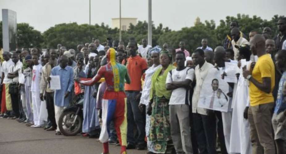 People await Mali's interim President Dioncounda Traore's arrival at Bamako airport.  By Habibou Kouyate AFPFile