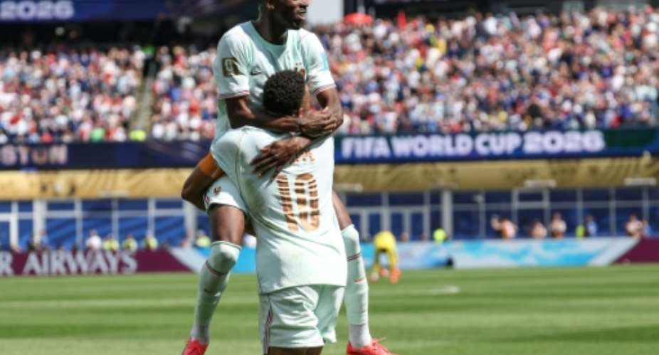 Frances Ousmane Dembele celebrates scoring his teams third goal in a victory over Norway as Les Bleus clinched first place in Group I.  By FRANCK FIFE (AFP)