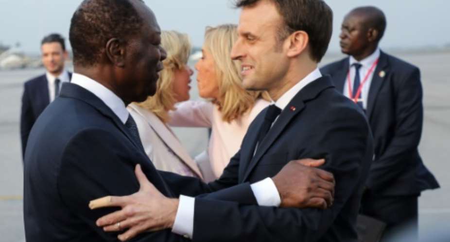 France's President Emmanuel Macron R was greeted by Ivory Coast's President Alassane Ouattara.  By LUDOVIC MARIN AFP