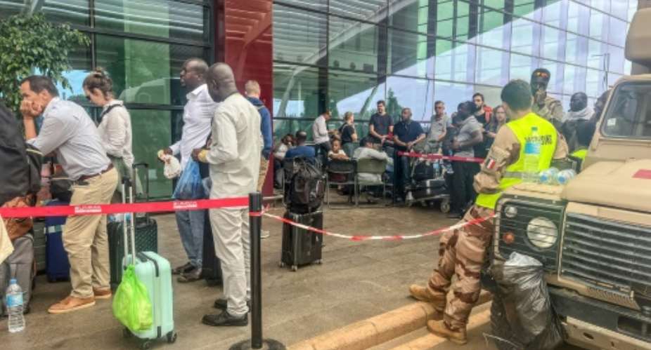 French and other European citizens at Niamey's Diori Hamani International Airport on Wednesday, where French soldiers were also deployed.  By Stanislas Poyet AFP