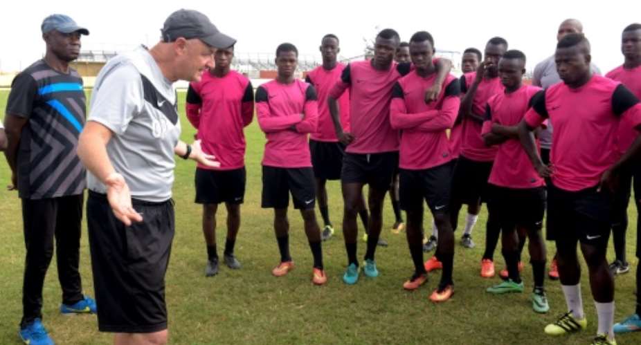 French coach Olivier Perrin gives Generation Foot players a pep talk: the side won the Senegalese national championship in early June.  By SEYLLOU (AFP)