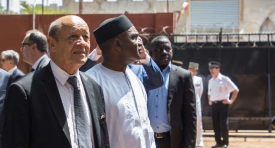 French Foreign Affairs Minister Jean-Yves Le Drian, left, with Burkina Faso's Foreign Affairs Minister Alpha Barry at the inauguration of an education and start-up incubator in Ouagadougou on October 19, 2018.  By OLYMPIA DE MAISMONT AFP