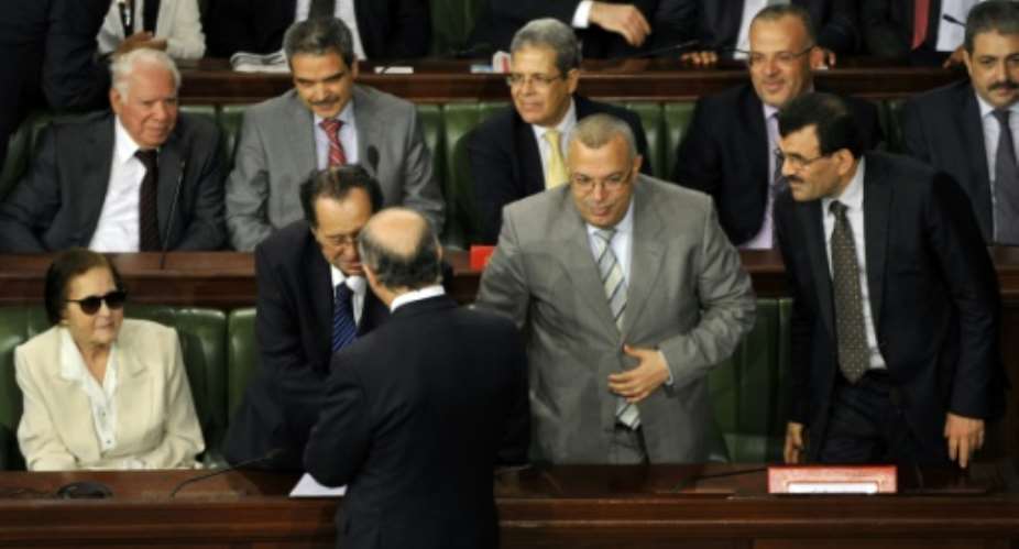 French Foreign Affairs Minister Laurent Fabius front greets Noureddine Bhiri 2R with other Tunisian politicians in Tunisia's Constituent Assembly on July 5, 2013.  By FETHI BELAID AFPFile