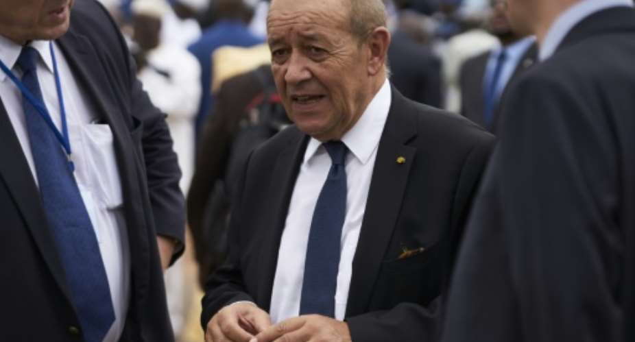 French Foreign Minister Jean-Yves Le Drian C, seen here at an independence ceremony in Mali September 22, has called for stronger sanctions against Libyans blocking a political solution in that country.  By Michele CATTANI AFPFile
