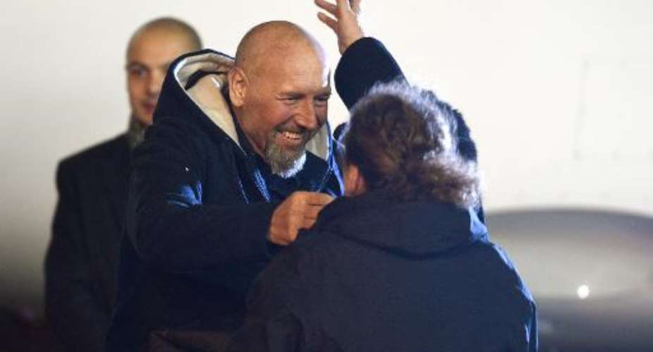 Relatives greet Serge Lazarevic L, France's last remaining hostage, after he landed at Villacoublay military base near Paris on December 10, 2014.  By Martin Bureau AFP