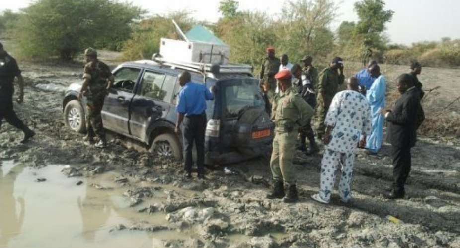 Police and soldiers gather on February 19, 2013, in Dabanga, around the 4x4 in which the kidnapped family had ridden.  By  AFPFile
