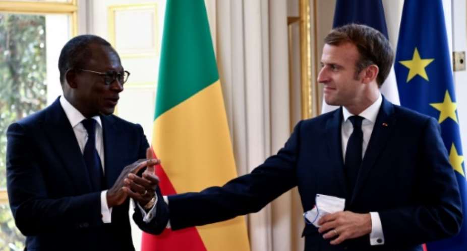 French President Emmanuel Macron L and Benin's President Patrice Talon R took part in the signing of an agreement to return looted cultural artefacts to the African country, at the Elysee Palace in Paris, on November 9, 2021.  By SARAH MEYSSONNIER POOLAFP