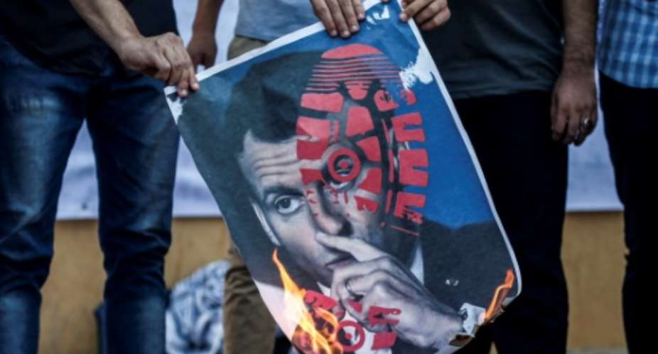 French President Emmanuel Macron's defence of cartoons depicting the Prophet Mohammed have sparked widespread protests, including here in Gaza on Tuesday, but in Tunisia it has triggered a wider debate.  By MAHMUD HAMS AFP
