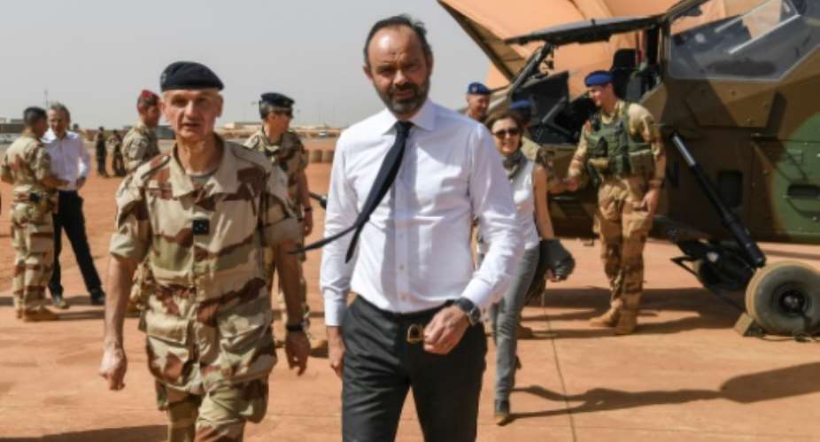 French Prime Minister Edouard Philippe, flanked by General Frederic Blachon, commander of the Barkane force, said Paris' partners must commit to the long haul to end jihadist violence in the Sahel.  By ALAIN JOCARD AFP