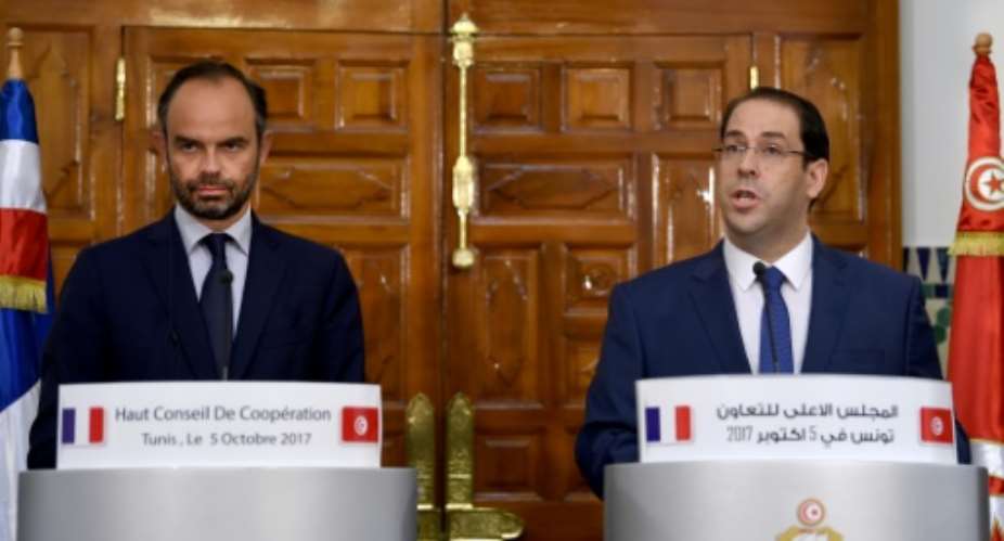 French Prime Minister Edouard Philippe L gives a press conference with his Tunisian counterpart Youssef Chahed R following a meeting in Tunis on October 5, 2017.  By FETHI BELAID AFP