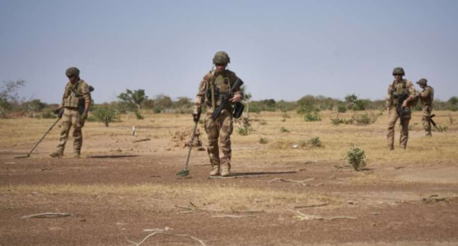 French soldiers use detectors while searching for IEDs Improvised Explosive Devices, which kill scores each year in the jihadist-hit Sahel region.  By MICHELE CATTANI AFP