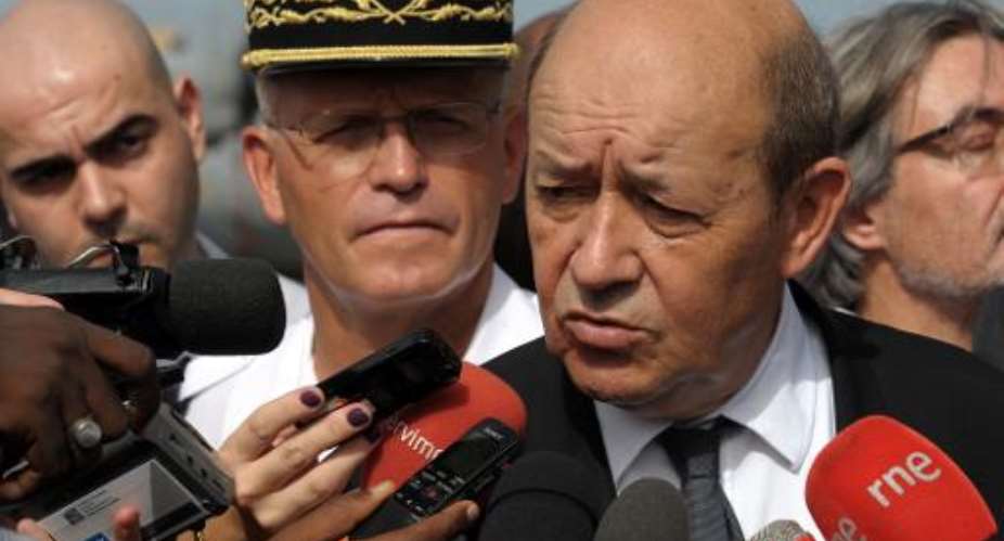 French Defense Minister Jean-Yves Le Drian speaks to the press during a visit to a French military airforce base in Dakar, October 24, 2014.  By Seyllou AFPFile