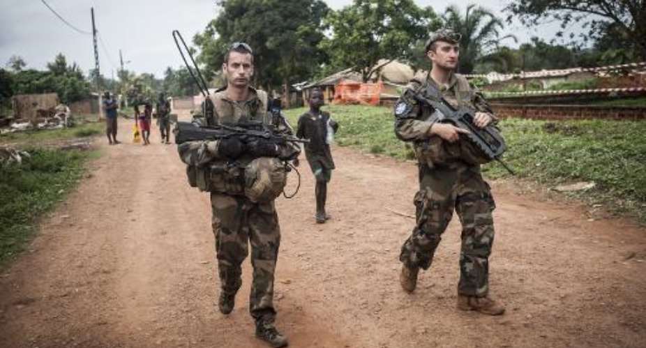 Soldiers of the French Sangaris force patrol in the muslim neighborhood of Boda, a mainly Christian town in the south of the country, on July 24, 2014.  By Andoni Lubaki AFP