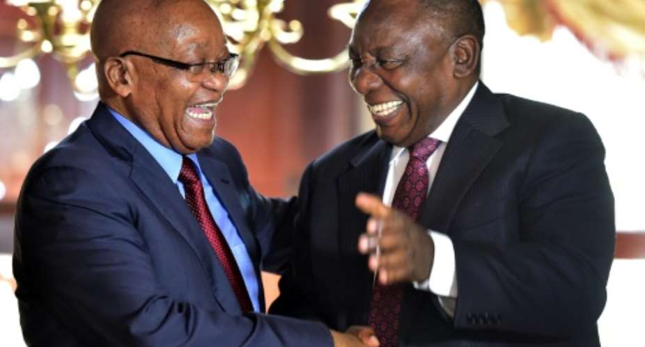 Frenemies? Zuma, left, and Ramaphosa shake hands at a farewell cocktail function for Zuma, in a picture released by the South African government.  By Kopano Tlape GCISAFP