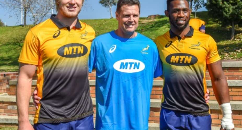 From L The Springboks' lock Pieter-Steph du Toit, head coach Rassie Erasmus and flanker Siya Kolisi pose for a photo ahead of a training session in Johannesburg, on May 28, 2018.  By Christiaan Kotze AFPFile