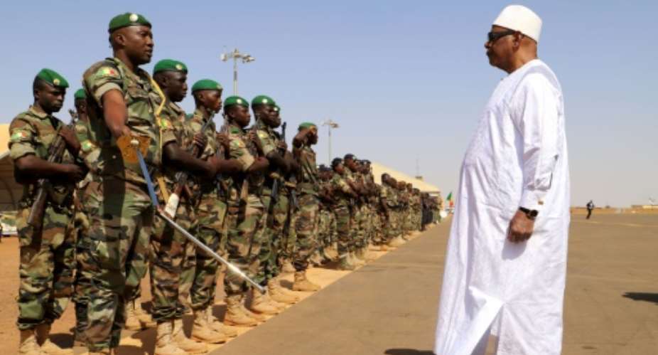 Front line: President Ibrahim Boubacar Keita inspects troops on a visit earlier this month to Gao, in Mali's volatile central region.  By Souleymane Ag Anara AFP