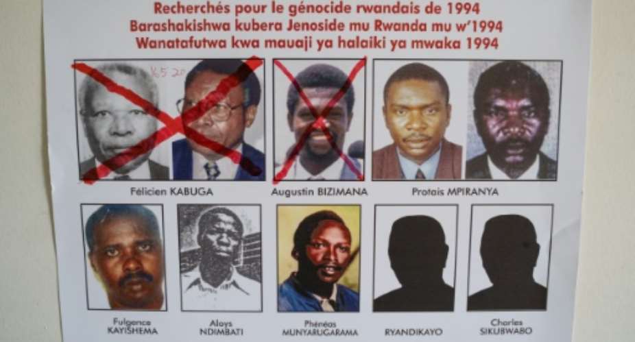 Fulgence Kayishema, bottom left, pictured in May 2020 on a wanted poster at the Genocide Fugitive Tracking Unit office in Kigali, Rwanda.  By Simon Wohlfahrt (AFP/File)