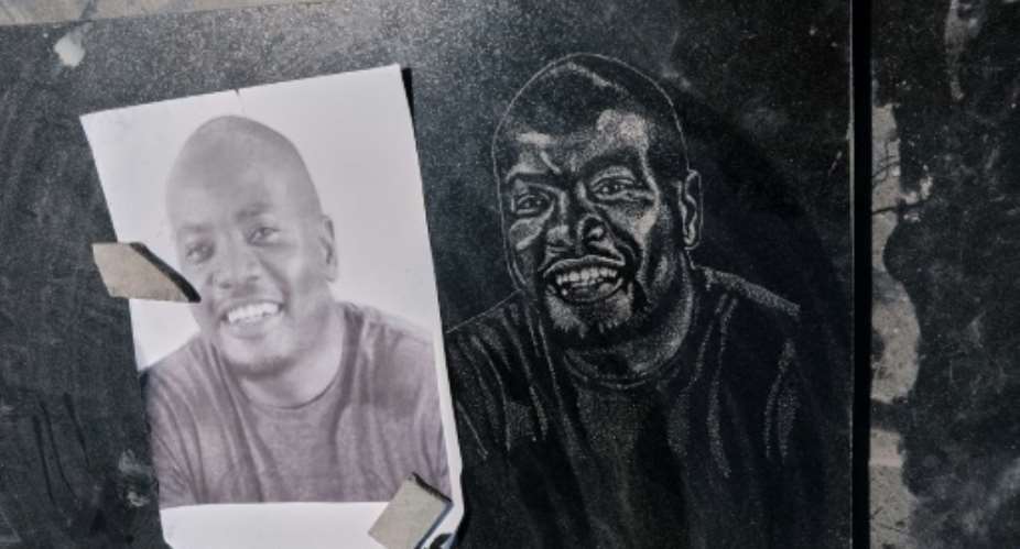 Funeral fashion: Hand-carved portraits on tombstones have become a lucrative business in Zimbabwe.  By Jekesai NJIKIZANA (AFP)