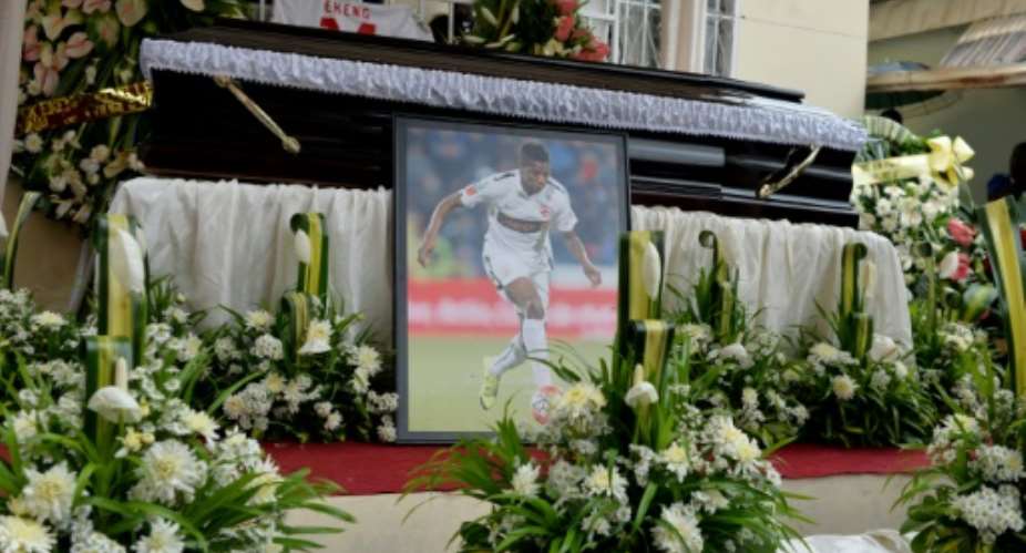 The casket and portrait of international soccer star Patrick Ekeng, who died after collapsing during a match in Romania, during his funeral in Yaounde on May 15, 2016.  By Reinnier Kaze AFP