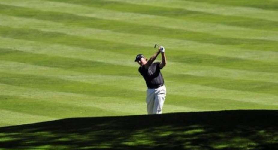 South African golfer Ernie Els plays his approach shot to the 3rd green.  By Glyn Kirk AFP