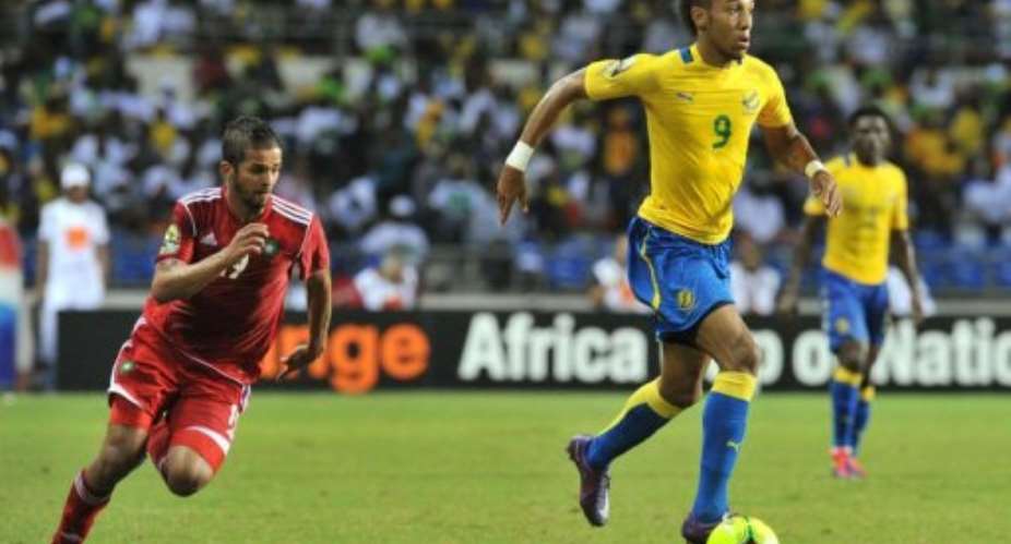 Gabon's striker Pierre-Emerick Aubameyang R duels for the ball with Morocco's Garcele Mehdi Francois.  By Issouf Sanogo AFP