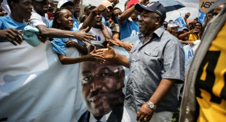 Gabon President Ali Bongo greets supporters in Moanda ahead of presidential elections.  By Marco Longari AFP