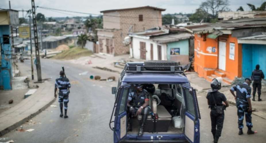 Gabonese police officers patrol near a barricade in the streets of Libreville on September 2, 2016.  By Marco Longari AFPFile