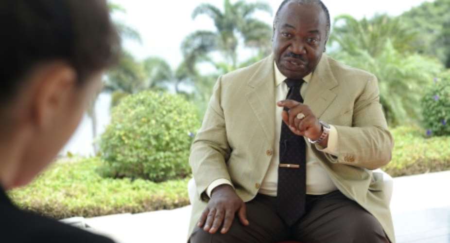 Gabonese President Ali Bongo Ondimba gestures as he speaks to journalists during an interview in Libreville, on August 12, 2016.  By Steve Jordan AFPFile