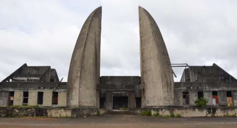 The entrance of the abandoned headquarters of the International Centre of Bantu Civilisations CICIBA, with its two concrete structures representing elephant tusks, pictured in Libreville, on August 25, 2014.  By Celia Lebur AFPFile