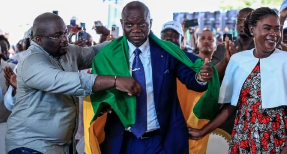 Gabons junta chief Brice Oligui Nguema (2nd R) won the presidency with 94.85 percent of the vote, according to final results.  By Daniel BELOUMOU OLOMO (AFP/File)