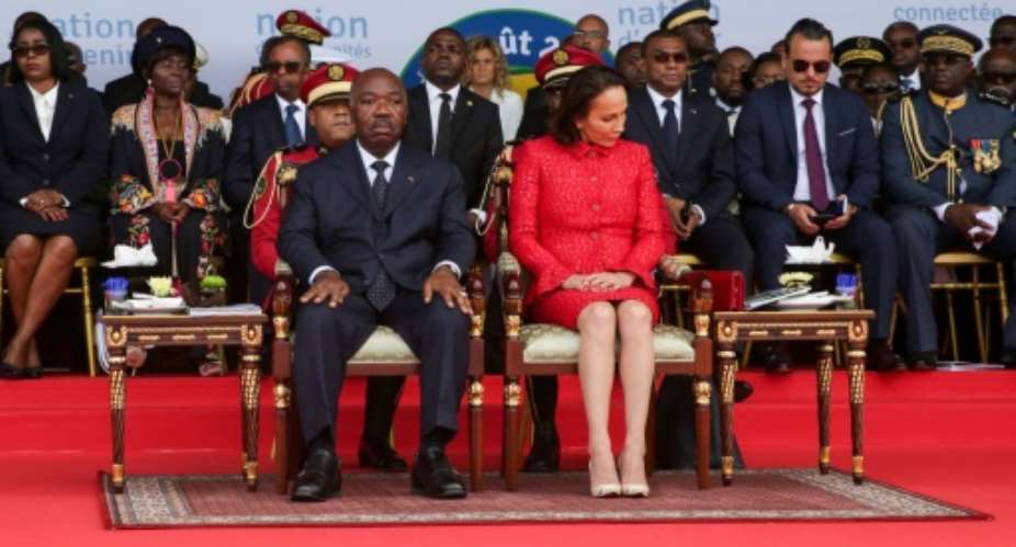 Gabon's President Ali Bongo and the First Lady attend a ceremony in August 2019. Bongo's then cabinet director Brice Laccruche Alihanga is second to the right behind the presidential couple.  By Steve JORDAN AFPFile
